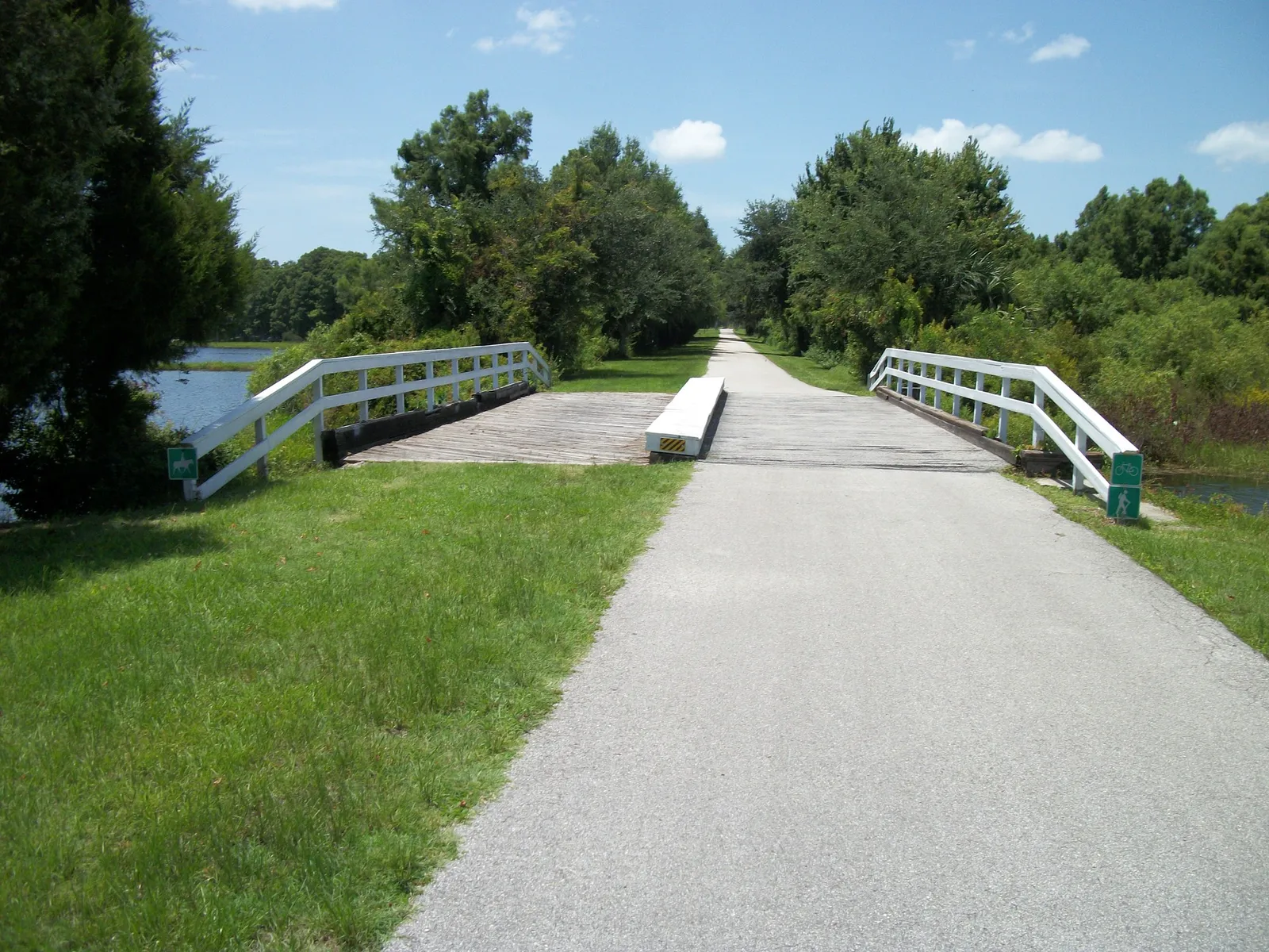 Paved nature trail crossing a bridge near Henderson Lake